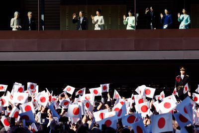 Japanese emperor and his family greet flag-waving crowd at the palace for New Year's