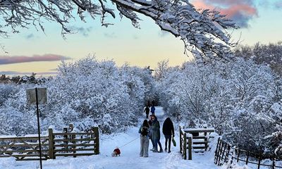 UK weather: airports reopen but travel disruption continues – as it happened