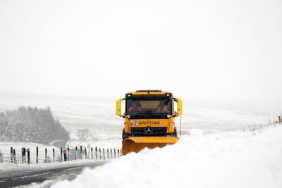 In Pictures: Floods and heavy snow as winter arrives with a vengeance