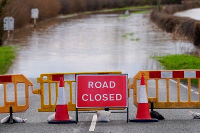 Severe flooding and snow disrupt travel as weather warnings remain