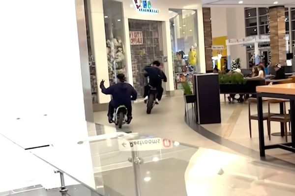 Chaos as dirt bike riders race through food court in bustling California shopping mall