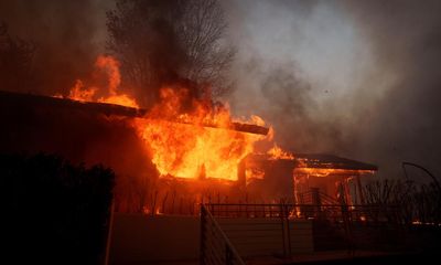 Tens of thousands of people ordered to evacuate as deadly blazes spread through neighborhoods in Los Angeles – as it happened