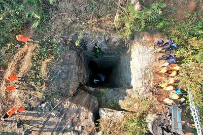 Indian army divers retrieve the body of one of at least 9 miners trapped in a flooded coal mine