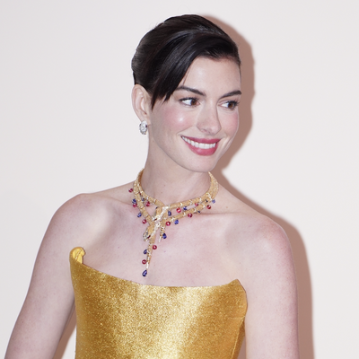 Anne Hathaway Goes Full Audrey Hepburn in a Golden Midi Dress, $475 Christian Louboutin Pumps, and Bulgari Jewels