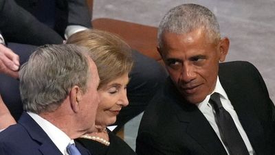 George W Bush pats Barack Obama’s belly as he takes seat at Jimmy Carter’s funeral