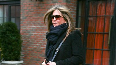 Jennifer Aniston offers timeless outfit inspiration in skinny jeans and knee high boots - her oversized scarf is a winter staple