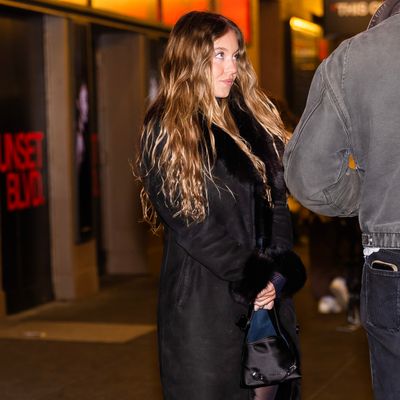 Sydney Sweeney Winterizes a Plunging Mini Dress With a Sheer Turtleneck and a Fur-Lined Penny Lane Coat