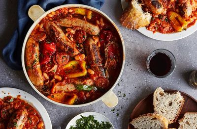 Baked sausages with sweet and spicy peppers, beans and chorizo – recipe