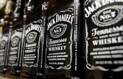 Jack Daniels' parent Brown-Forman is cutting its workforce and closing its barrel-making plant