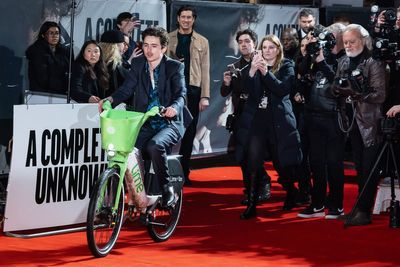 Timothee Chalamet arrives at A Complete Unknown UK premiere on a Lime bike