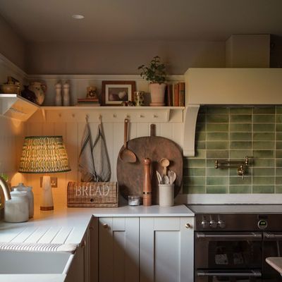 This kitchen has been turned from dark and dated to romantic and cosy with a clever colour scheme and design tricks