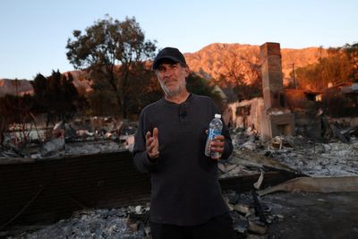 Dozens of LA residents – some armed – are defying evacuation orders to protect their homes in ‘Wild West’