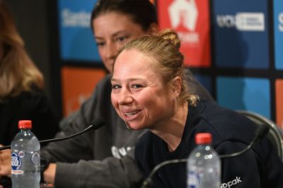 Justine Ghekiere carrying defending champions' banner for Women's Tour Down Under