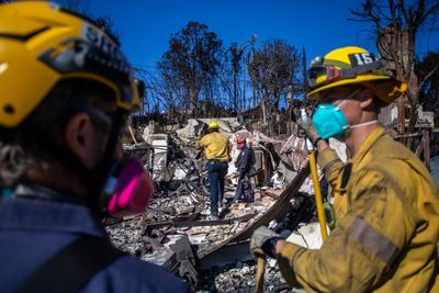 Power utility sued over woman’s death as crews make progress against LA fires