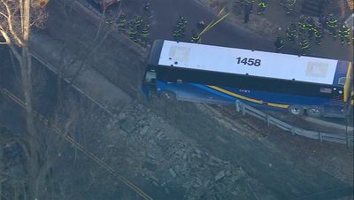 Front of NYC bus left hanging near a Bronx overpass after accident