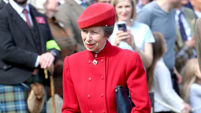 Princess Anne was the epitome of vibrant elegance in cherry red coat and tartan skirt for grand opening