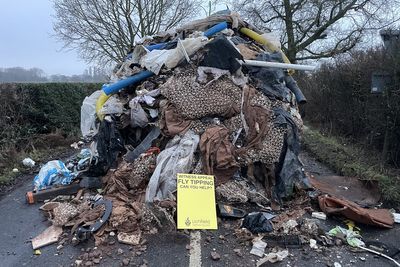 Two tipper trucks believed to be involved in fly-tipping 10ft-high waste mound