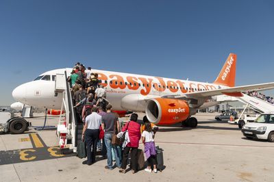 EasyJet halves losses amid lower fuel costs and package holiday boost. 'We have one million more customers already booked' says CEO