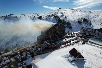 Witnesses at a Turkish ski resort stood helpless as people leaped out of a burning hotel