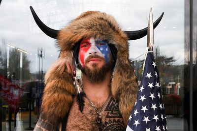 Self-styled 'QAnon Shaman' screams 'freedom' as he reacts to Trump pardon