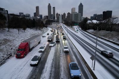 Georgia drivers sleep in cars after being stuck for 15 hours when snow storm lightly covers roads and paralyzes communities