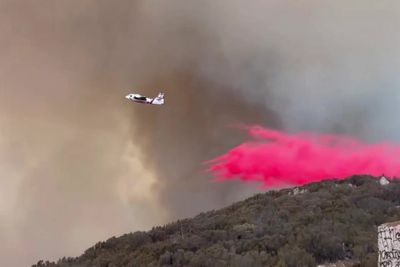 Firefighters tackle raging San Diego wildfire blaze from air with pink powder