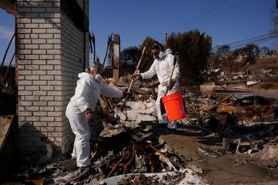 Evacuated residents wait hours for a chance to return to burned LA neighborhoods