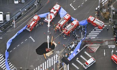 Race to rescue driver trapped in Japan sinkhole for two days