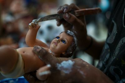 AP PHOTOS: The moment to restore broken baby Jesus figurines has come in Mexico