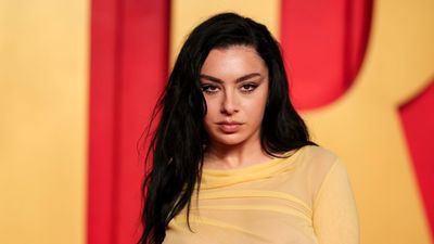 Charli XCX's gold sofa makes her living room feel 'lived-in but intentional' – the retro piece pairs with her Tudor-inspired wooden features