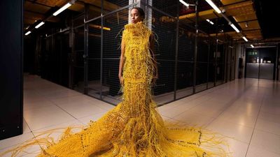 'Somewhat robot, somewhat human': designer used 12,000ft fiber optic cable to weave a striking 50lb dress that will turn heads - and no, you can't buy it