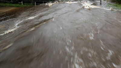 'They're gone': panic after men swept away by flood