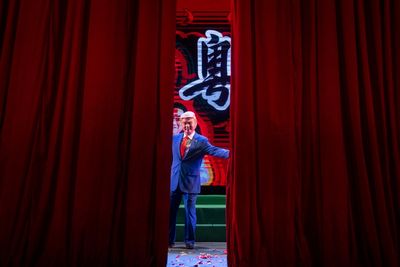 AP PHOTOS: In a modern twist to Cantonese opera, Trump sings in Chinese and wins cheers in Hong Kong