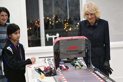 Camilla wins mini F1 race during visit to new school in east London