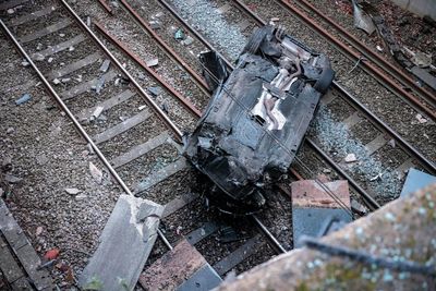Driver arrested after car crashes onto Manchester train tracks closing railway line