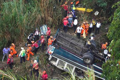 At least 51 die in Guatemala after bus plunges off bridge into a ravine 115 feet below