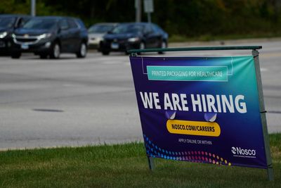 The number of Americans seeking jobless benefits falls as employers continue to hold on to workers