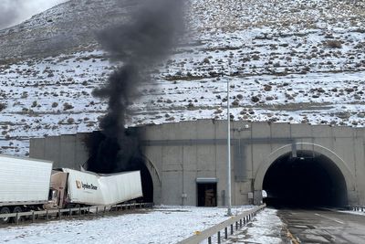 Investigators enter a highway tunnel in Wyoming where a fiery crash killed 2