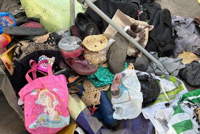 Passengers belongings lie at India railway station as stampede kills 18