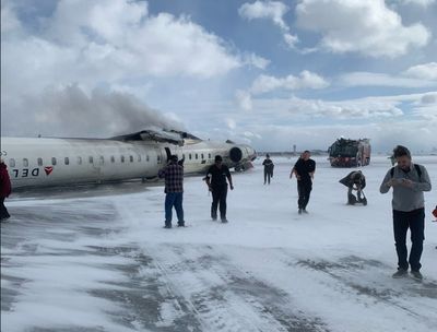 Delta Plane Passenger Records Herself Hanging Upside Down After Toronto Crash