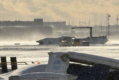 Video: Delta plane lies upside-down after Toronto airport crash