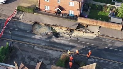 Massive 60ft sinkhole opens in middle of UK high street as buildings forced to evacuate