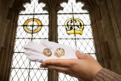 Brooches which copy London palace’s stained glass windows return home