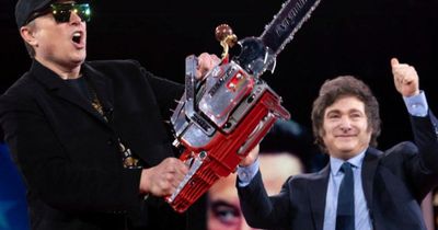 Elon Musk waves chainsaw on stage during American conservative conference