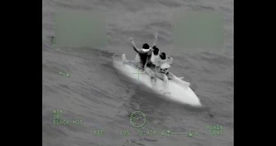 Coast Guard crews rescue three boaters stuck at sea for 9 hours after their boat capsizes