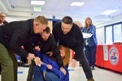 Idaho town hall meeting turns chaotic after woman is forcibly removed for heckling speakers