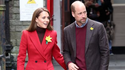 Kate Middleton braves the rain in fiery red coat and sumptuous brown knit as she makes subtle accessory switch-up