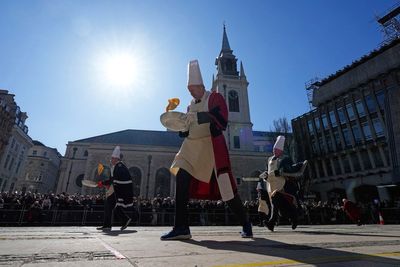 Hundreds cheer as runners with fry pans race to mark Pancake Day