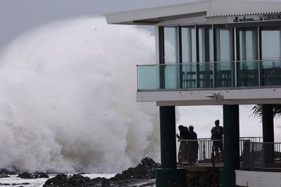 Schools are closed and public transport has stopped as rare cyclone approaches Australian coast