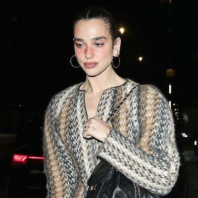 Dua Lipa Styles Her Statement Sweater Dress With a Chanel Cargo Bag and Furry Trouser Boots